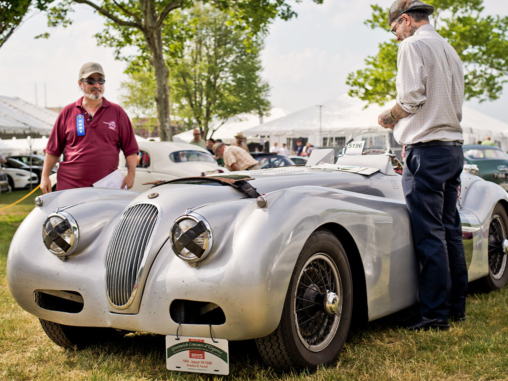 two men judging silver vintage car at Greenwich Concours